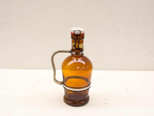 Vintage amber glass bottle with wire bail and decorative stopper, perfect for display or use.