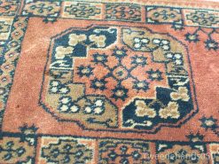 Elegant vintage area rug with octagonal pattern and warm earthy tones, enhancing your decor.