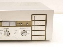 Vintage Akai audio amplifier with sleek silver design and versatile input options for home audio.