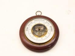 Vintage wooden barometer for nautical decor, featuring a polished finish and visible mechanics.