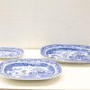 Elegant vintage blue and white porcelain plates set, showcasing intricate landscapes and craftsmanship.