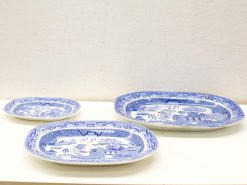 Elegant vintage blue and white porcelain plates set, showcasing intricate landscapes and craftsmanship.