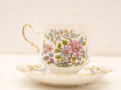 Elegant vintage teacup and saucer with pastel floral design, perfect for tea parties.