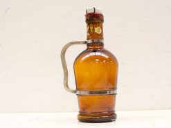 Vintage brown glass bottle with chrome lever cap and ergonomic metal handle.