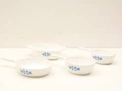 Elegant vintage white ceramic dishes with blue floral pattern for stylish serving.