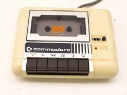 Vintage 1980s Commodore cassette tape player with original buttons and nostalgic design.