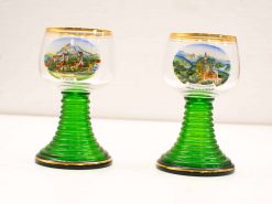 Vintage decorative glasses featuring scenic landscapes and gilded rims, perfect for collectors.