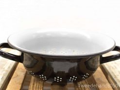 Vintage black enameled colander with white interior, perfect for draining pasta and washing vegetables.