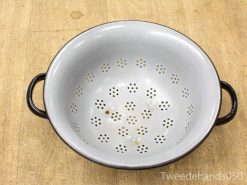 Vintage gray enamel colander with floral pattern and black handles for easy draining.