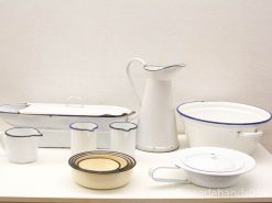 Charming vintage enamel kitchenware collection featuring a basin, pitcher, and unique patterned bowl.