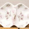 Elegant vintage ceramic dish with floral design, perfect for serving appetizers or desserts.