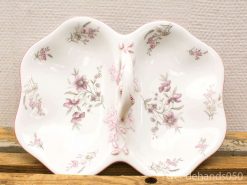 Elegant vintage ceramic dish with floral design, perfect for serving appetizers or desserts.