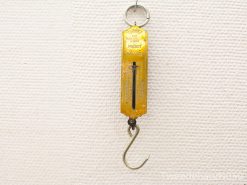 Vintage yellow pocket balance scale for precise weighing of small items.