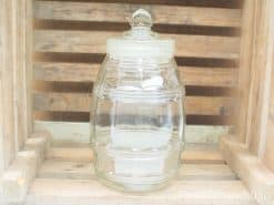 Vintage glass jar with lid for stylish storage and rustic home decor.