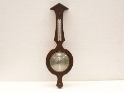 Vintage wooden barometer with thermometer, elegant design for weather forecasting and decoration.