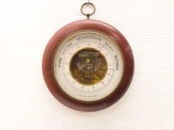 Elegant vintage wooden barometer with detailed pressure gauge and rich reddish-brown finish.