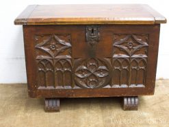 Intricate vintage wooden chest with ornate carvings and decorative metal clasp.