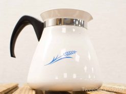 Vintage coffee carafe with blue wheat design and ergonomic black handle, perfect for collectors.