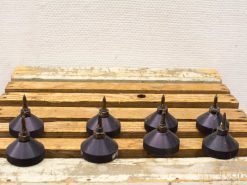 Set of 8 vintage metallic tops on rustic wooden table, perfect for collectors and decor.