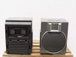 Vintage stereo speakers on a wooden crate, blending retro charm with modern sound design.