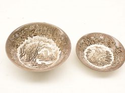 Vintage ceramic bowls featuring intricate landscape and coastal designs, perfect for collectors.