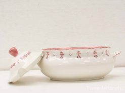 Elegant vintage ceramic casserole dish with pink floral design and scalloped edges.