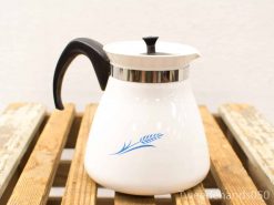 Elegant vintage white kettle with wheat design, black handle, and stainless steel rim.