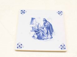 Charming blue and white tile depicting an older woman and a traveler in warm conversation.