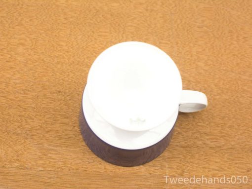 Elegant white coffee mug on rustic wooden table, perfect for cozy moments.