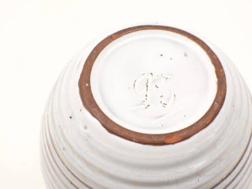 Vintage ceramic bowl with glossy white glaze and distinct brown rim, featuring JF embossed mark.