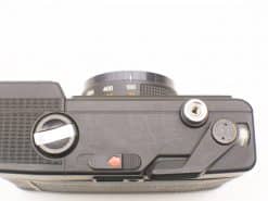 Vintage film camera with lens and mechanical controls, perfect for passionate photographers.