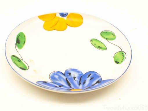 Vibrant decorative plate with yellow and blue floral patterns, ideal for casual dining and display.