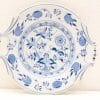 Elegant blue and white decorative plate with botanical motifs, perfect for artful serving.