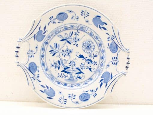 Elegant blue and white decorative plate with botanical motifs, perfect for artful serving.