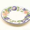 Vibrant floral decorative plate, perfect for display and versatile use in any table setting.