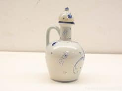 Elegant blue and white ceramic pitcher with intricate designs, perfect for decoration or utility.