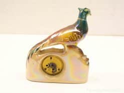 Vibrant handcrafted ceramic pheasant, blending vintage charm with exquisite colors for striking decor.