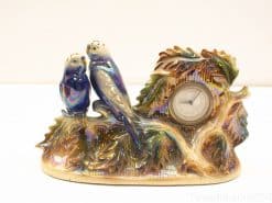 Iridescent decorative clock with ceramic birds and leaf motifs, perfect for home decor.