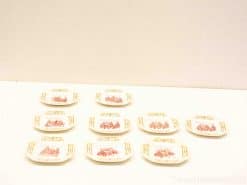 Elegant oval plates featuring intricate red and gold designs, perfect for decoration or special occasions.