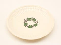 Elegant cream decorative plate with vibrant ivy leaf design, perfect for serving or display.