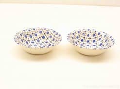 Elegant ceramic bowls with blue floral patterns, perfect for serving snacks and desserts.