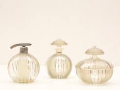 Set of three vintage glass bottles showcasing elegant designs and artisanal craftsmanship.