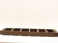 Elegant wooden tray with seven compartments for stylish organization in home or office.