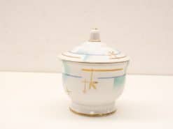 Elegant porcelain container with lid and gold accents, perfect for decorative displays and accents.