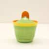 Colorful round container with green body, yellow rim, and orange knob, perfect for storage.