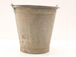 Rustic vintage metal bucket with handles, perfect for gardening or decorative use.