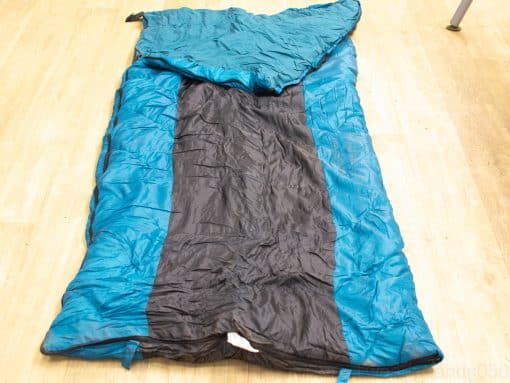 Vibrant teal and black sleeping bag for outdoor adventures, combining style, warmth, and comfort.