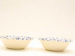 Charming vintage ceramic bowls with intricate blue floral patterns, perfect for decor and everyday use.