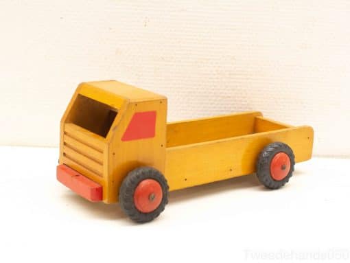 Charming yellow wooden toy truck with red wheels, perfect for imaginative play and creativity.