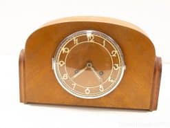 Elegant vintage wooden tabletop clock with classic design and cream numbers for timeless decor.